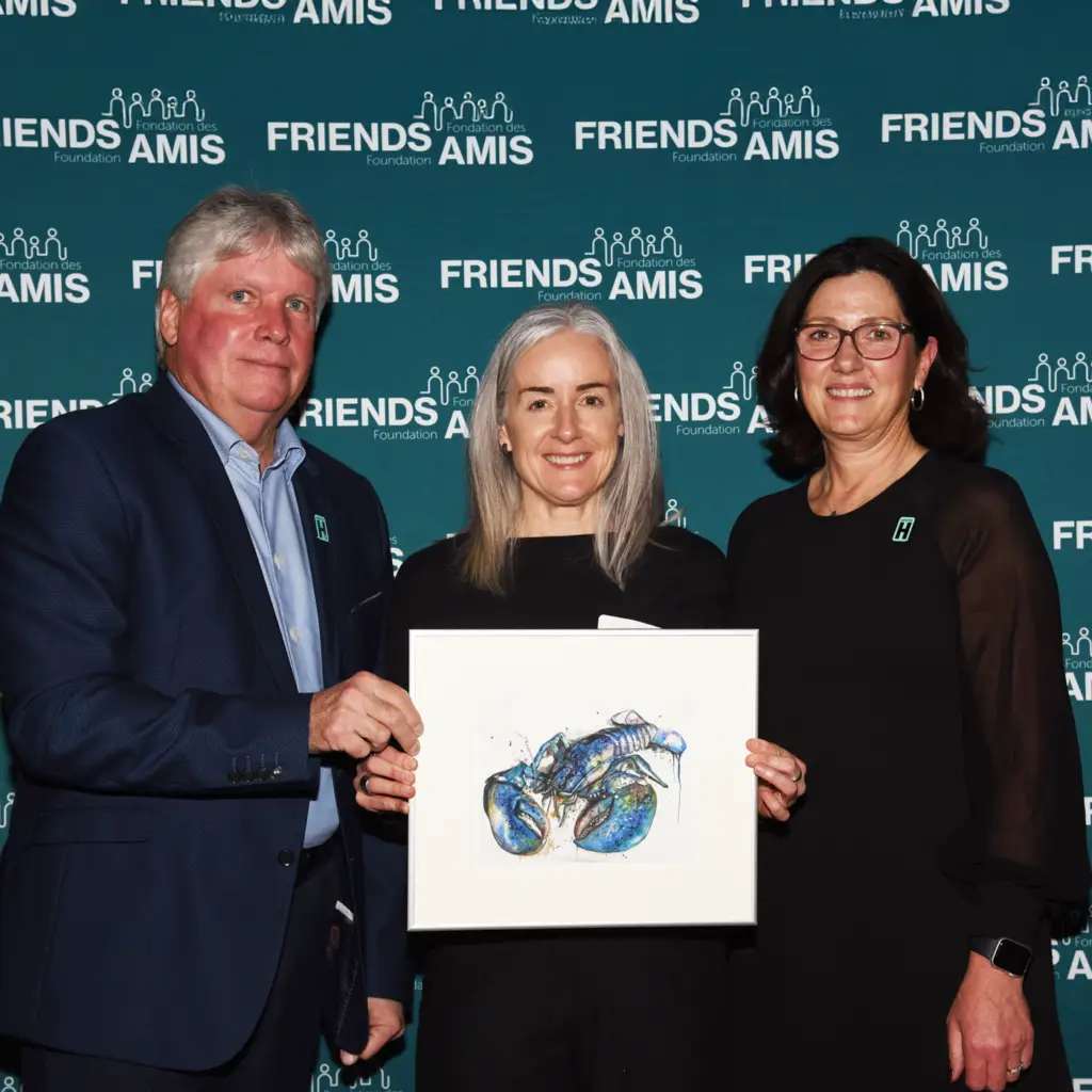 Artist holding artwork